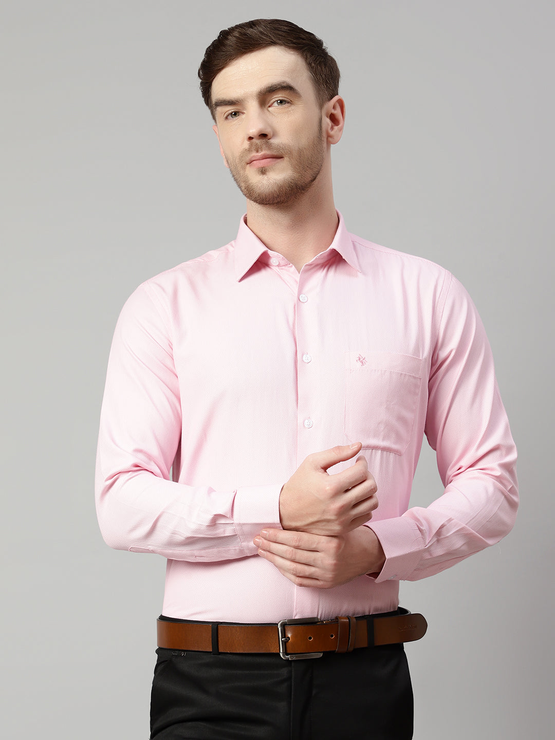a man wearing a pink shirt and black pants and white shoes Stock Photo by  Icons8